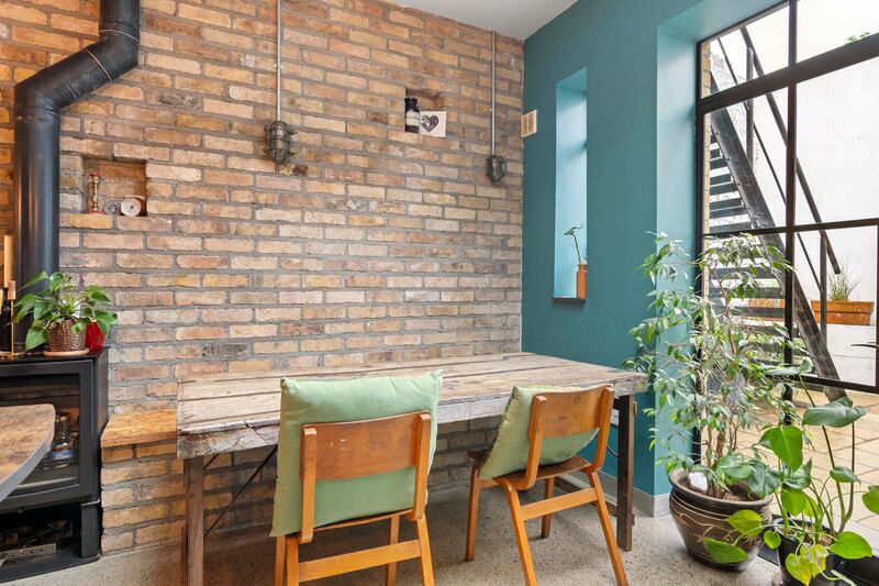 Owners re-used the old back wall to create interest in the dining area