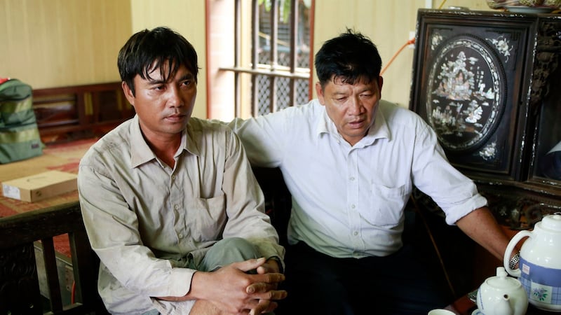 Doan Van Binh and Doan Van Thanh, brother and father of Doan Thi Huong, one of the two women accused of killing Kim Jong Nam, talk to reporters at their house in Nghia Binh village, Nam Dinh province, Vietnam. Photograph: AP Photo/ Hau Dinh