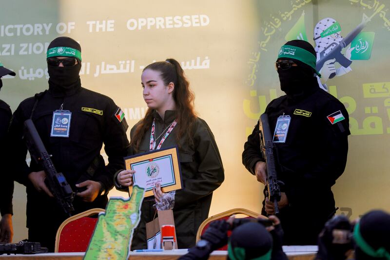 Hamas militants escort Israeli hostage Agam Berger, centre, before handing her to a Red Cross team in Jabalia on January 30. Photgraph: Saeed Jaras/Getty