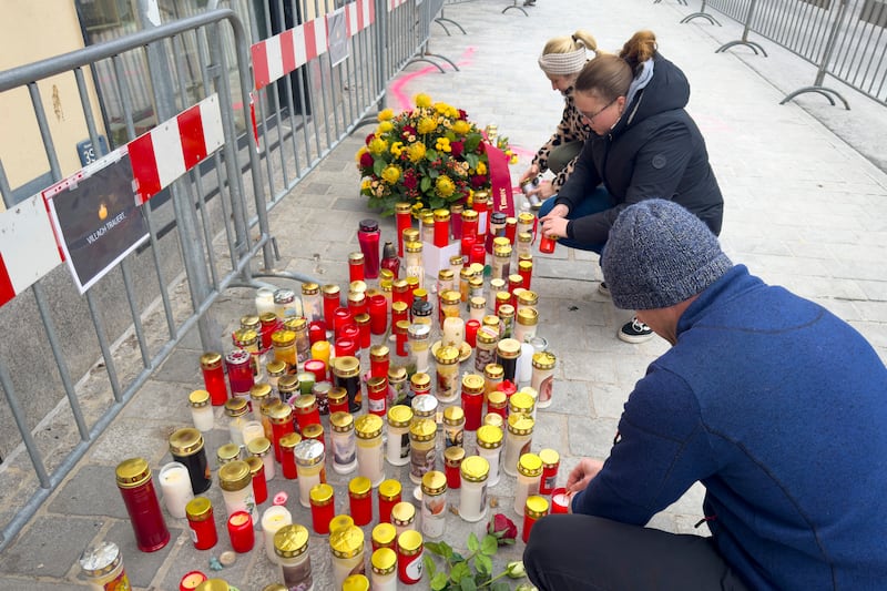 Candles have been left at the scene of the attack. Photograph: Darko Bandic/AP)