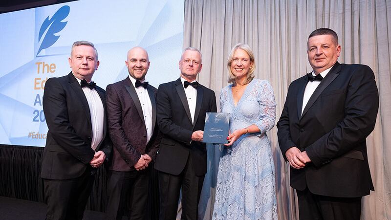 Dr. Ciarán Ó hAnnracháin, awards judge, presents the Best Community Academic Collaboration award to Munster Technological University team