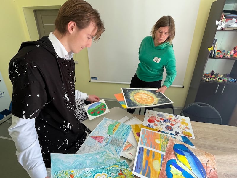 Nataliya Gubyak and son Oleksandr look through some of his artwork at the Centre for Support and Protection shelter in Lviv in western Ukraine. Photograph: Daniel McLaughlin