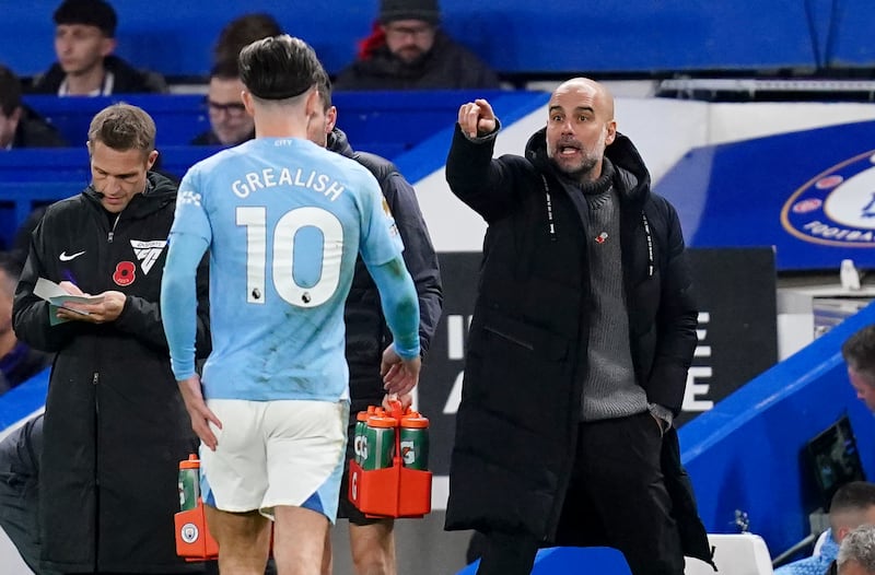 Manchester City manager Pep Guardiola with Jack Grealish on the touchline at Stamford Bridge, London, in 2023. Photograph: John Walton/PA Wire