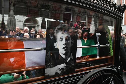 Crowds line Dublin streets to cheer, sing and bid farewell to ‘huge legend’ Shane MacGowan 