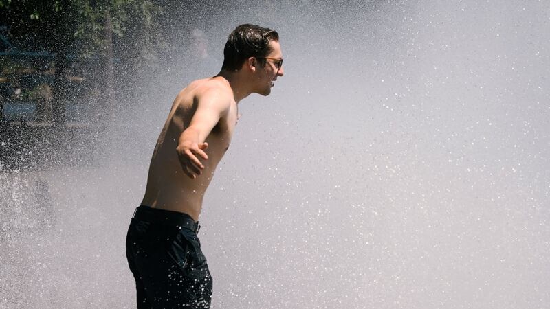 A man cools off in the Salmon Street springs fountain in Portland, Oregon on Monday. Photograph: Getty Images