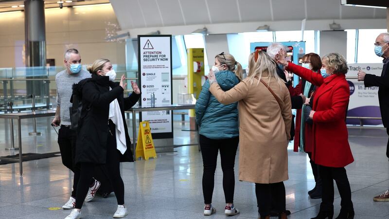 Róisín Heaney and Kevin Gillycuddy (left), departing for Toronto, wave goodbye to their parents and siblings at Dublin Airport.