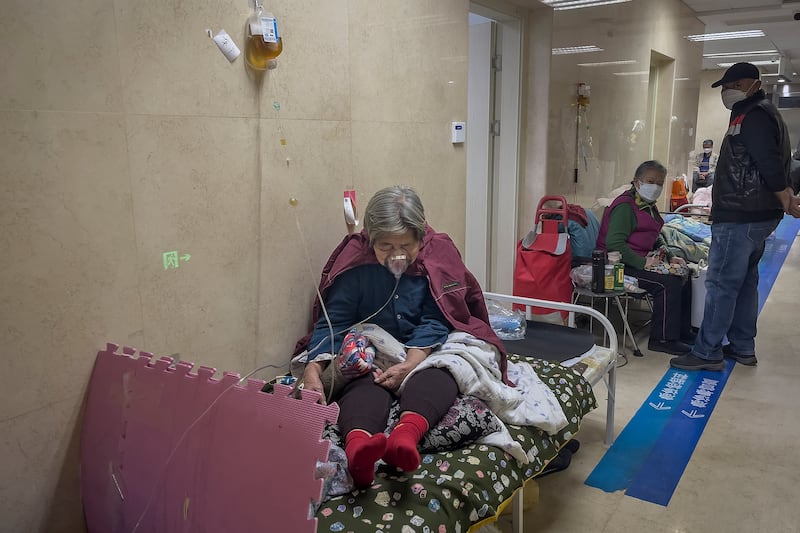 An elderly patient using a ventilator in the corridor of the emergency ward at a hospital in Beijing. Photograph: Andy Wong/AP