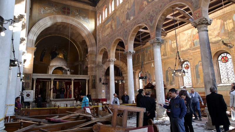 People inspect the damage inside St. Peter and St. Paul Coptic Orthodox Church after a bombing in Cairo on Sunday. The St. Peter and St. Paul church is  a small chapel attached to the Coptic Cathedral. Photograph: EPA