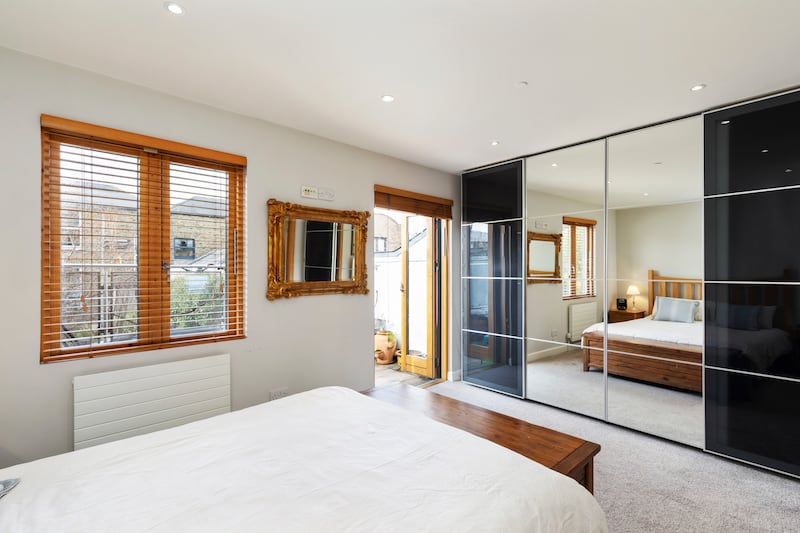 The principal bedroom was originally two bedrooms and opens out to a balcony