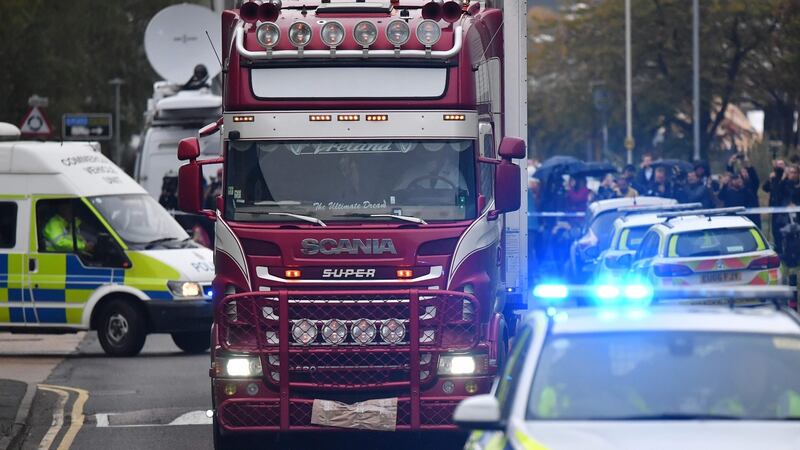 Police officers drive away the  lorry in which 39 dead bodies were discovered. Photograph: Getty