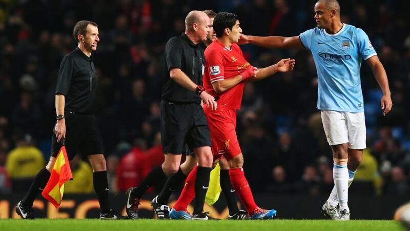 Manchester City captain Vincent Kompany dismisses Luis Suarez’s complaint in the St Stephen’s Day match at the Etihad Stadium while referee Lee Mason looks on. Photograph: Alex Livesey/Getty Images