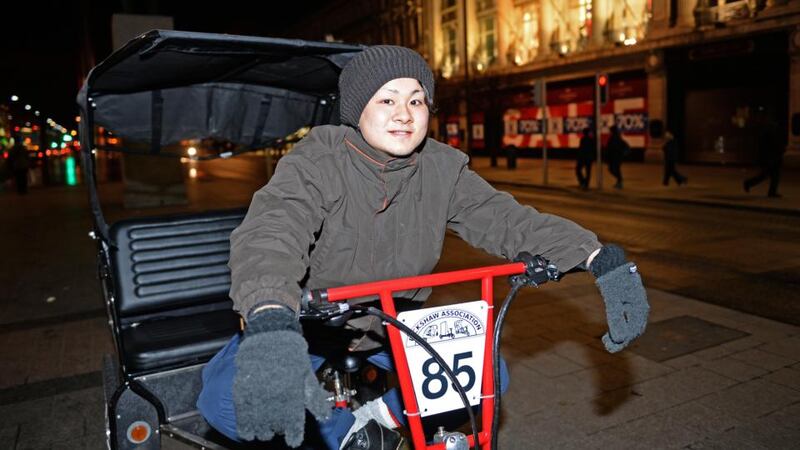 15/01/2014     WEEKEND  Akihito Nakasuga with his rickshaw . O'Connell street , Dublin, by night . Photograph:  Eric Luke  /  The Irish TimesFor spl in Weekend by Patrick Freyne