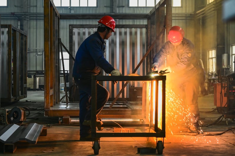 Employees cut materials at the workshop of Xinjiang Ganneng Electric Technology Company in Changji Hui Autonomous Prefecture, Xinjiang, earlier this month. Photograph: Tao Weiming/VCG /Getty