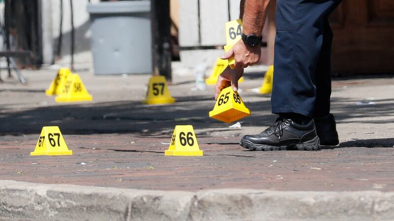 Authorities remove evidence markers at the scene of a mass shooting in Dayton, Ohio. Photograph: John Minchillo/AP Photo