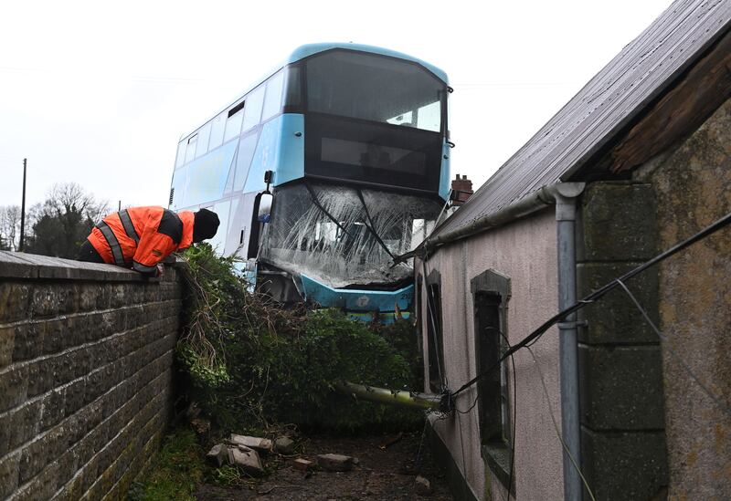 An airport transfer bus left the road and hit a wall in Templepatrick in Co Antrim during Storm Darragh. Photograph: Charles McQuillan/Getty Images