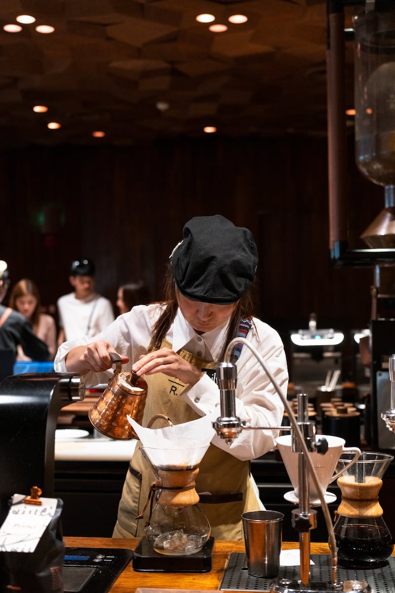 A barista brewing coffee for customers in Shanghai Starbucks Reserve Roastery. Photograph: Zhang Peng/LightRocket via Getty Images