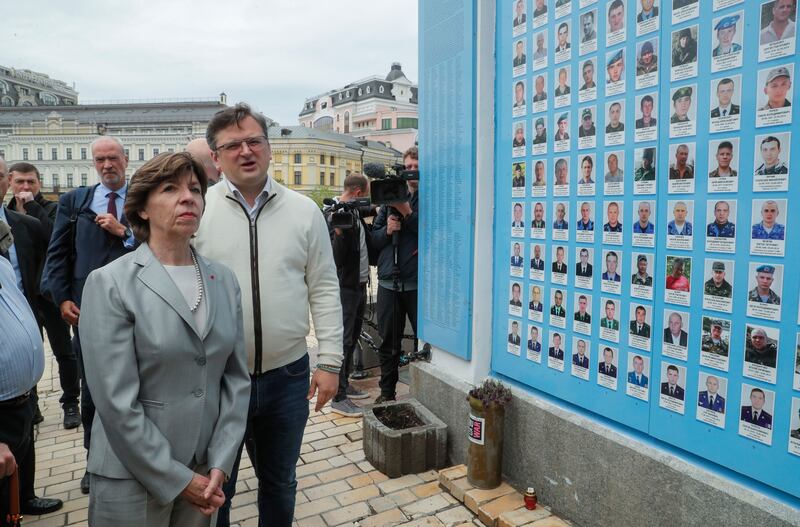 Ukraine's foreign minister, Dmytro Kuleba, and French foreign minister Catherine Colonna at a ceremony at the Memory Wall of fallen Ukrainian defenders, near the St Mikhail cathedral in Kyiv.