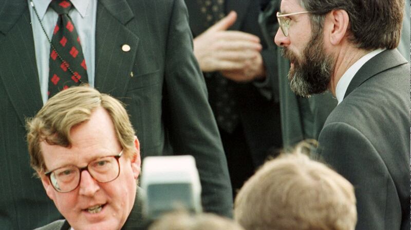 Ulster Unionist leader David Trimble, left, crosses the path of Sinn Fein President Gerry Adams outside a press room at the Stormont Castle a couple of days before the Good Friday Agreement was signed. Photograph: Paul McErlane/AP