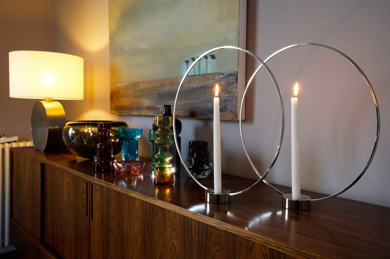 Rosewood sideboard: A collection of vintage glass, a large glass bowl by Holmegaard filled with cones and battery-lights, along with Gloria by Klong, candle holders to add depth. Photograph: Nick Bradshaw