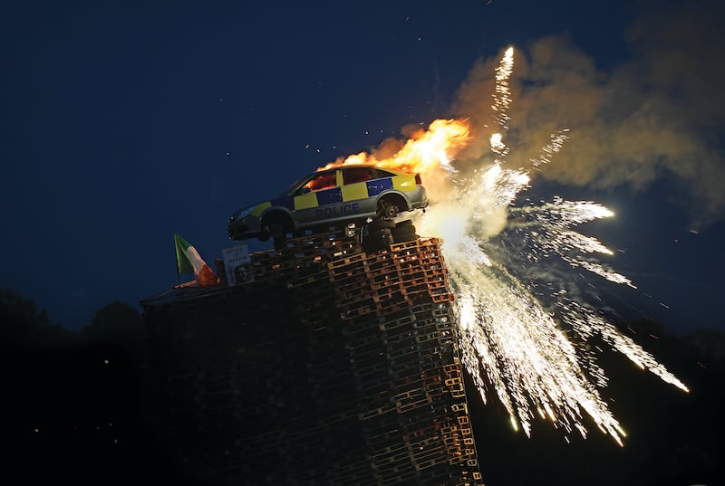 TOWERING INFERNO: A mock police car is set alight at an Eleventh Night bonfire in Moygashel, Co. Tyrone. Photograph: Niall Carson  / PA Media