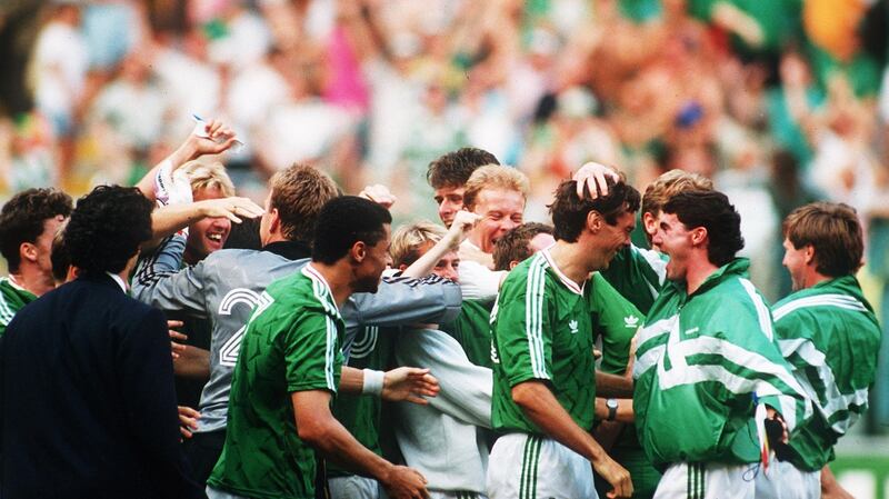 David O’Leary is congratulated by his Ireland team-mates after converting the winning penalty against Romania. Photograph: Billy Stickland/Inpho