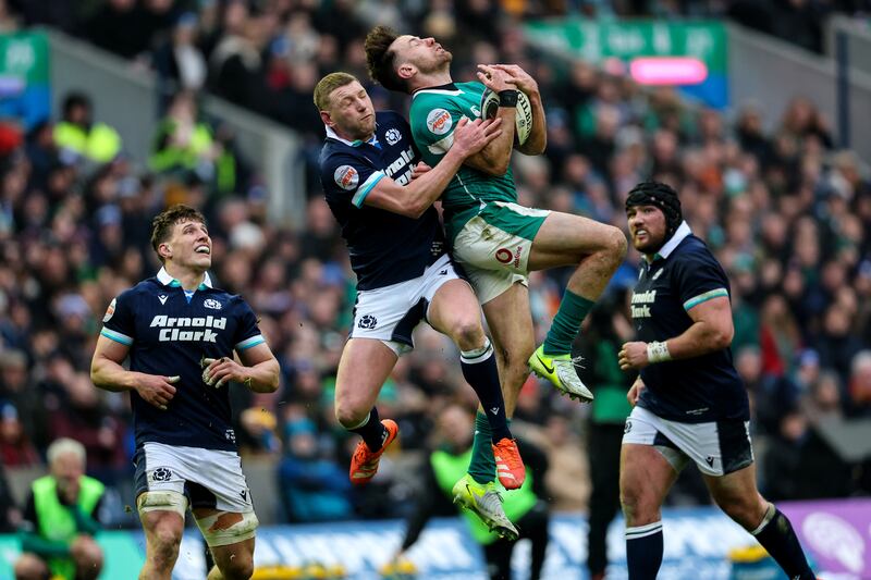 Scotland's Finn Russell loses out to Ireland's Hugo Keenan for a high ball. Photograph: Billy Stickland/Inpho