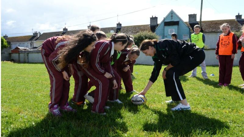 Maire Louise Reilly of the Irish Womens Team plays ball with the school’s pupils. Photograph: Brenda Fitzsimons