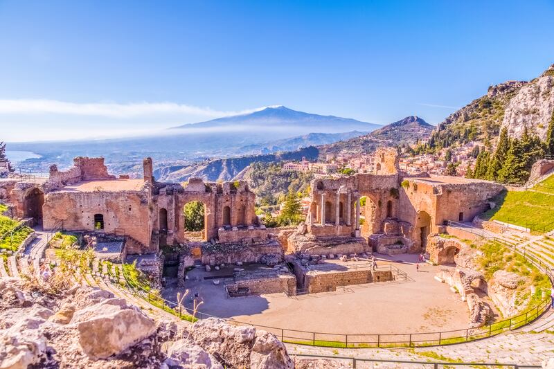 The Greek Theater of Taormina, flanked by  smoking volcano Etna