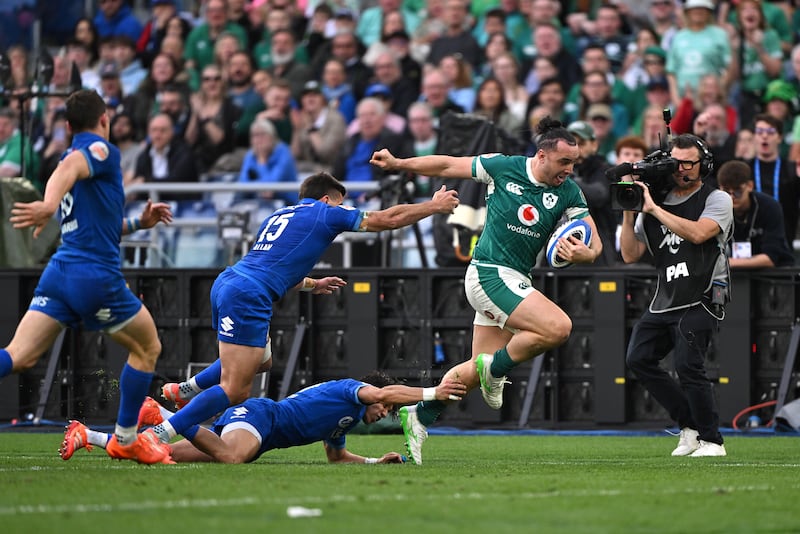 Ireland's James Lowe of Ireland breaks with the ball whilst under pressure from Ange Capuozzo and Tommaso Allan of Italy. Photograph: Mike Hewitt/Getty Images