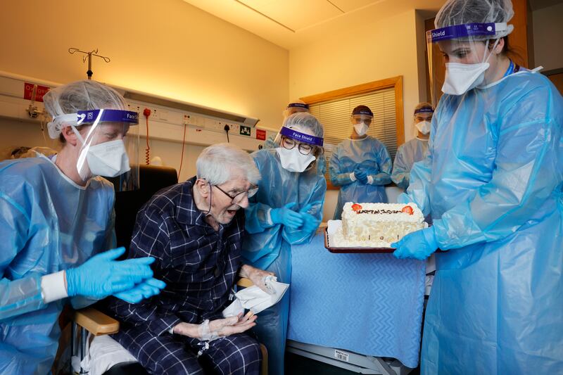 Staff at St Monica's Covid ward in St Vincent University Hospital celebrating Bernard Duffy's 101st Birthday with a cake. Duffy was unable to have visitors. Photograph: Alan Betson