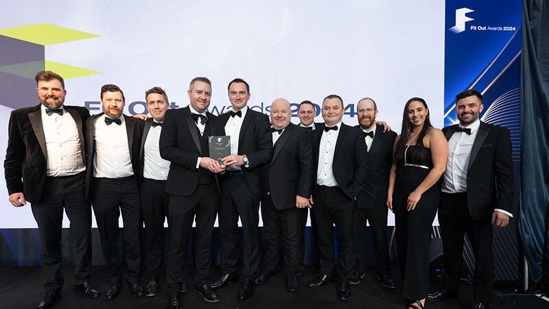 Shaun Bonner, group sales director of Etag, presents the fit out contractor of the year award to T&I Fitouts team