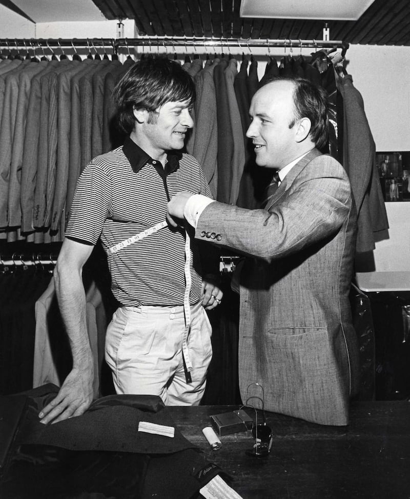 Snooker player Alex Higgins being measured for a waistcoat by Louis Copeland in his Capel Street store in 1982. Photograph: Peter Thursfield