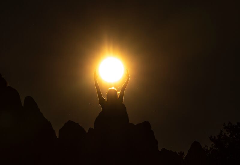 A girl reacts as the sun rises on the Summer Solstice from behind a rocky crest filled with astronomical stone markers at the ancient megalithic observatory of Kokino, North Macedonia on Wednesday. Photograph: Georgi Licovski/EPA-EFE