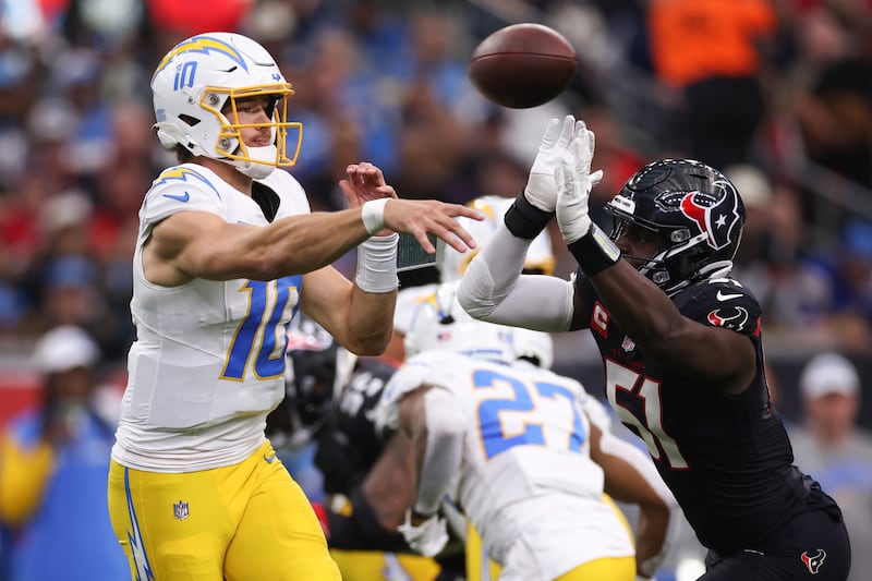 Justin Herbert of the Los Angeles Chargers throws a pass while under pressure against Will Anderson of the Houston Texans during the AFC Wild Card Playoffs. Photograph: Tim Warner/Getty Images