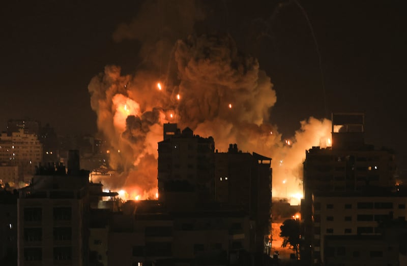 Fire and smoke rise above buildings in Gaza City during an Israeli air strike on Sunday, October 8th, 2023. Photograph: Mahmud Hams/AFP via Getty Images