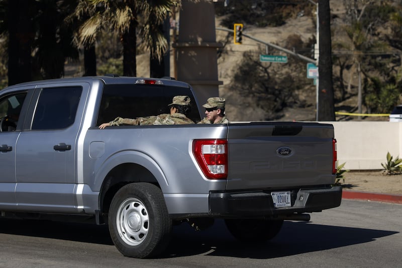 A National Guard vehicle drives through the Pacific Palisades neighbourhood. Photograph: Caroline Brehman/EPA-EFE