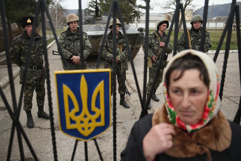 A woman stands outside a Ukrainian military base surrounded by several hundred Russian-speaking soldiers in Crimea on March 2nd, 2014 in Perevalne, Ukraine. Photograph:  Sean Gallup/Getty 