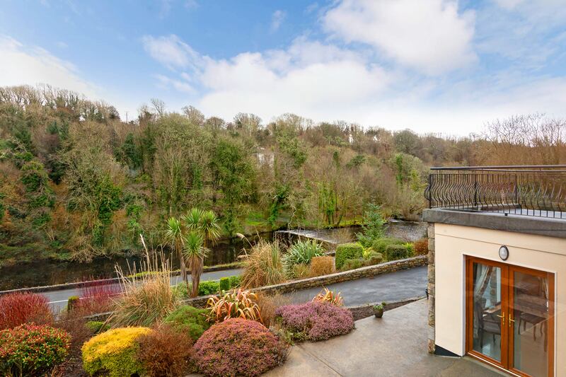 The property has mature gardens overlooking the river.