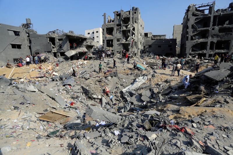 Palestinians wander among debris of buildings that were targeted by Israeli airstrikes in Jabaliya refugee camp, northern Gaza. Photograph:   AP