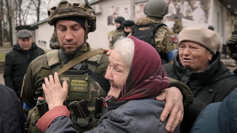 A woman hugs a Ukrainian serviceman after a convoy of military and aid vehicles arrived in the formerly Russian-occupied Kyiv suburb of Bucha, Ukraine. Photograph: Vadim Ghirda/AP