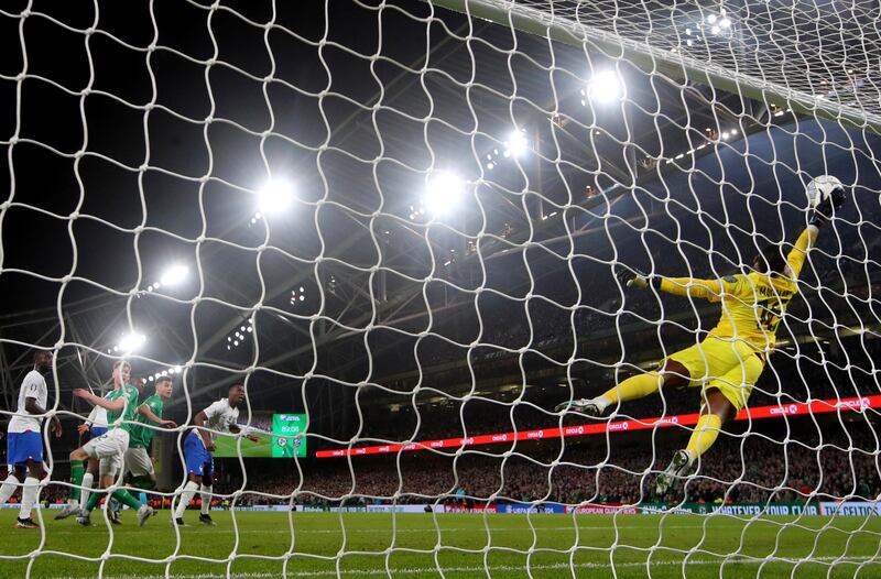 France's Mike Maignan makes a save from Nathan Collins of Ireland’s header. Photograph: Ryan Byrne/Inpho