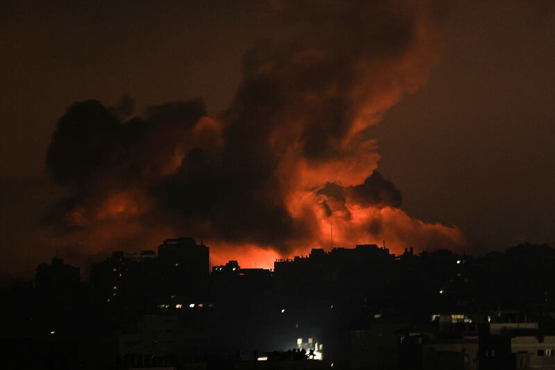 Fire and smoke rise above buildings in Gaza City during an Israeli air strike. Photograph: Mahmud Hams/AFP via Getty Images