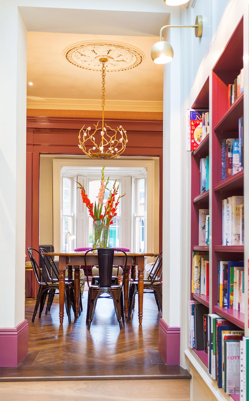 This area is filled with light from overhead glazing and includes open bookshelves and glazed presses for less-used serveware