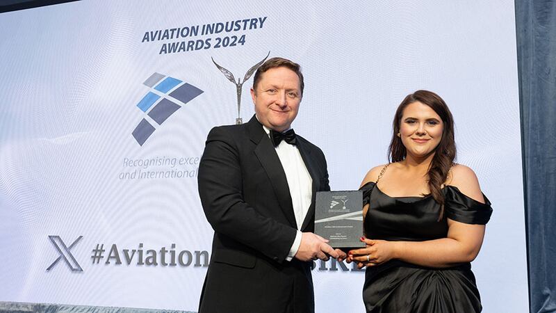 Wayne Tyrell, awards judge, presents the aviation CSR achievement award to Nicole Kelly, Belfast City Airport