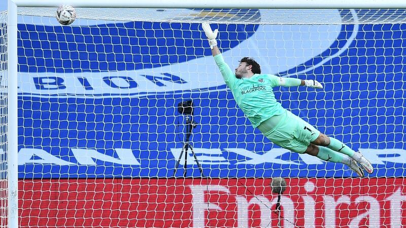 Blackpool goalkeeper Chris Maxwell can’t stop  Yves Bissouma’s strike. Photograph: Glyn Kirk/Getty/AFP