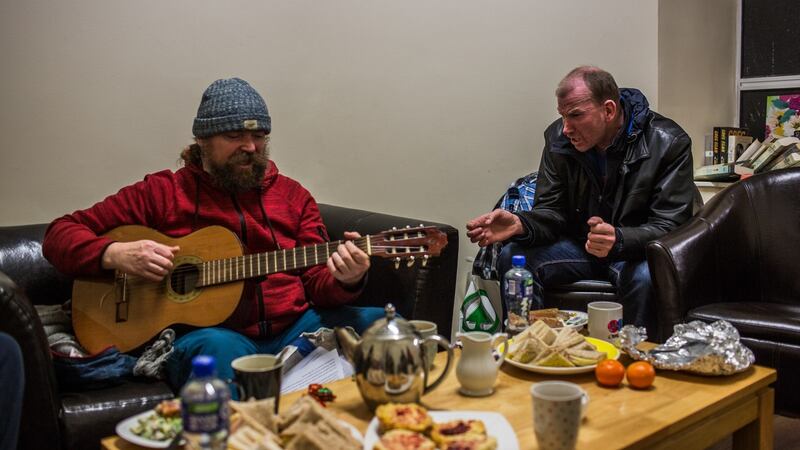 Two homeless men play music and sing at a social club event at the Simon community centre in Dublin. Photograph: James Forde