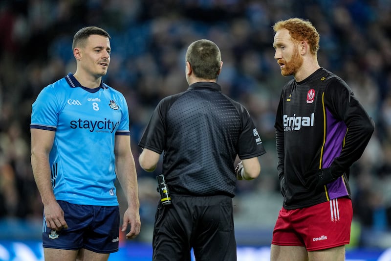 Dublin's Brian Howard with Derry's Conor Glass and referee Noel Mooney. Photograph: James Lawlor/Inpho