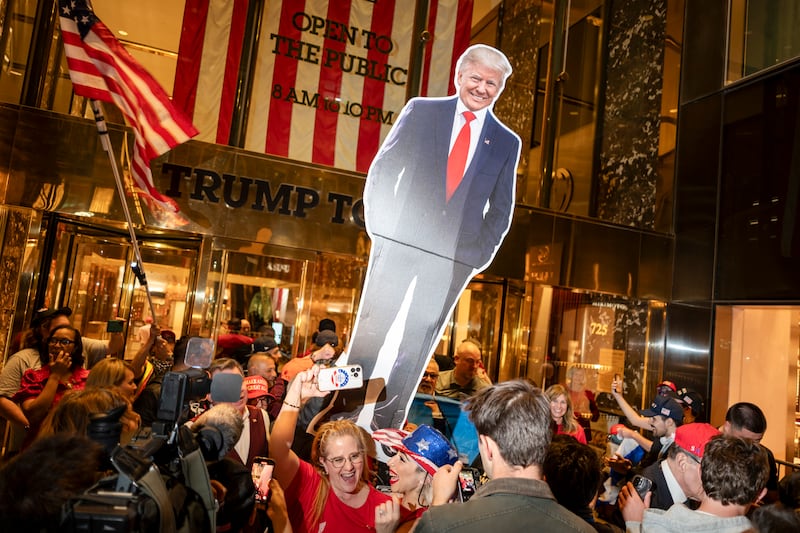 People raise a cardboard cutout of Donald Trump outside Trump Tower, in New York. Photograph: Karsten Moran/The New York Times