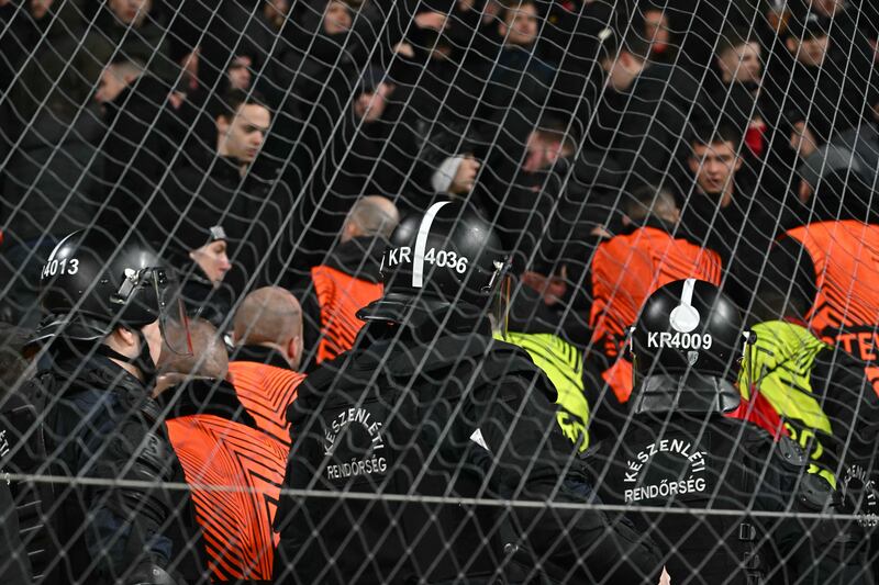 Police officers secure tha area as AZ Alkmaar's fans fought with security guards during the Uefa Europa League match between Ferencváros and AZ Alkmaar. Photograph: Attila Kisbenedek/AFP via Getty Images