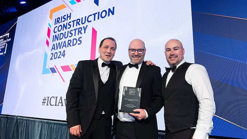 Tony Campbell, associate director at KCC Group, presents the contractor education project of the year award to Colm Rodgers and Daniel Hart, Glasgiven Contracts